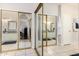 En suite bathroom with white cabinets, double sinks, and a mirrored closet at 9004 S Ash Ave, Tempe, AZ 85284