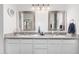Stylish bathroom featuring dual sinks with granite countertops, framed mirrors, and modern fixtures for a clean, fresh look at 9004 S Ash Ave, Tempe, AZ 85284
