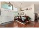 Elegant dining area featuring hardwood floors, a chandelier, and ample natural light from the windows at 9004 S Ash Ave, Tempe, AZ 85284