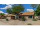 Attractive single-Gathering home with desert landscaping and a mature tree in the front yard at 9004 S Ash Ave, Tempe, AZ 85284