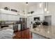 A view of the kitchen with stainless steel appliances and granite counters at 9004 S Ash Ave, Tempe, AZ 85284