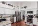 Well-appointed kitchen with stainless steel appliances, granite countertops, and white cabinets; bright and functional design at 9004 S Ash Ave, Tempe, AZ 85284