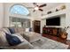 Comfortable living room featuring hardwood floors, a sectional sofa, and a large screen television at 9004 S Ash Ave, Tempe, AZ 85284