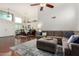 Bright living room featuring a comfortable sectional sofa, hardwood floors, and a view into the dining area at 9004 S Ash Ave, Tempe, AZ 85284