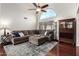 Cozy living room with a sectional, hardwood floors, custom window, and a stylish display cabinet at 9004 S Ash Ave, Tempe, AZ 85284