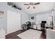 Bright office space with hardwood floors, ceiling fan, dual desks, and well-lit workspaces, ideal for working from home at 9004 S Ash Ave, Tempe, AZ 85284