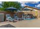 Relax by the pool with comfortable lounge chairs and tables, perfect for enjoying the outdoors at 9004 S Ash Ave, Tempe, AZ 85284