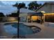 Tranquil backyard pool with lush greenery and comfortable outdoor seating for evening relaxation at 9004 S Ash Ave, Tempe, AZ 85284