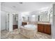 Luxurious bathroom featuring a central tub, dual vanities, and a walk-in closet for ultimate convenience at 970 S Henry Ln, Gilbert, AZ 85296