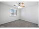 Bedroom with window, neutral carpet, and ceiling fan at 970 S Henry Ln, Gilbert, AZ 85296
