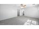 Bright bedroom with a ceiling fan and neutral carpet, leading to a bathroom at 970 S Henry Ln, Gilbert, AZ 85296