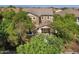 Two-story home with stone accents, neutral paint, and mature trees in community at 970 S Henry Ln, Gilbert, AZ 85296