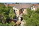 Exterior view of a two-story home surrounded by lush trees, showcasing its inviting facade at 970 S Henry Ln, Gilbert, AZ 85296