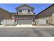 Rear view of a two-story home with a two-car garage, and private backyard at 970 S Henry Ln, Gilbert, AZ 85296