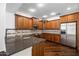 Well-appointed kitchen featuring wooden cabinetry, granite countertops, stainless steel appliances at 970 S Henry Ln, Gilbert, AZ 85296