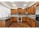 Beautiful kitchen with modern appliances, granite countertops, and rich wood cabinetry at 970 S Henry Ln, Gilbert, AZ 85296