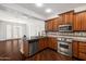 Modern kitchen featuring wood cabinets, granite countertops and stainless steel appliances at 970 S Henry Ln, Gilbert, AZ 85296
