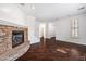 Bright living room with stone fireplace, hardwood floors, and open layout at 970 S Henry Ln, Gilbert, AZ 85296
