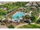 Aerial view showcasing the community pool area with palm trees, lounge chairs, and recreation space at 970 S Henry Ln, Gilbert, AZ 85296