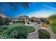 Expansive backyard featuring lush greenery, a sparkling pool, comfortable seating area, and manicured landscaping at 9845 E Edgestone Dr, Scottsdale, AZ 85255