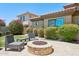 Backyard fire pit with patio and lush landscaping at 9845 E Edgestone Dr, Scottsdale, AZ 85255