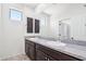 Bathroom with granite countertops, dual sinks, and dark wood cabinets at 9845 E Edgestone Dr, Scottsdale, AZ 85255