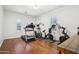 Well-equipped exercise room with hardwood floors, natural light, and various fitness machines for a complete workout at 9845 E Edgestone Dr, Scottsdale, AZ 85255