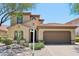 Charming two-story home showcasing a tile roof, well-maintained landscaping, and a spacious two-car garage at 9845 E Edgestone Dr, Scottsdale, AZ 85255