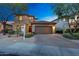 Charming two-story home exterior featuring a desert landscape, tile roof, and two-car garage at 9845 E Edgestone Dr, Scottsdale, AZ 85255