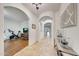 Open-concept foyer with arched doorways, hardwood floors, and decorative accents that enhance the home's appeal at 9845 E Edgestone Dr, Scottsdale, AZ 85255