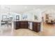 Open-concept kitchen features stainless steel appliances, dark wood cabinetry, and adjacent dining areas at 9845 E Edgestone Dr, Scottsdale, AZ 85255