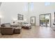 Comfortable living room with high ceilings, modern decor, and a view to the outdoor pool at 9845 E Edgestone Dr, Scottsdale, AZ 85255