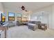 Bright living room with a comfortable sectional sofa and large windows with views at 9845 E Edgestone Dr, Scottsdale, AZ 85255