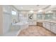 Bright main bathroom with walk-in shower, soaking tub, dual sinks, and vanity area at 9845 E Edgestone Dr, Scottsdale, AZ 85255