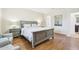 Well-lit main bedroom showcasing hardwood floors, neutral color scheme, and ensuite access at 9845 E Edgestone Dr, Scottsdale, AZ 85255