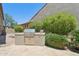 Outdoor kitchen featuring a built-in grill and stainless steel doors at 9845 E Edgestone Dr, Scottsdale, AZ 85255