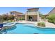 Backyard pool featuring a baja step and raised spa plus an outdoor kitchen and patio at 9845 E Edgestone Dr, Scottsdale, AZ 85255
