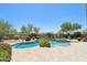 Inviting backyard pool and spa with lush desert landscaping and sunny blue skies at 9845 E Edgestone Dr, Scottsdale, AZ 85255