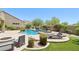 Relaxing backyard featuring a pool, spa, desert landscaping, and a lounge chair at 9845 E Edgestone Dr, Scottsdale, AZ 85255