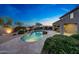 Stunning backyard featuring a sparkling pool, lush landscaping, cozy seating area, and a serene ambiance at 9845 E Edgestone Dr, Scottsdale, AZ 85255