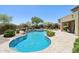 Backyard oasis featuring a sparkling pool, spa, and fire pit with lush landscaping at 9845 E Edgestone Dr, Scottsdale, AZ 85255