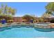 Detailed view of the pool's waterfall feature, tile accents, and well-maintained landscaping at 9845 E Edgestone Dr, Scottsdale, AZ 85255
