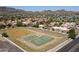 Aerial view of community tennis and basketball courts near residential area and desert mountains at 10410 N Cave Creek Rd # 2220, Phoenix, AZ 85020