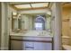 Well-lit bathroom with double sinks, a large mirror, and updated fixtures and cabinets at 10410 N Cave Creek Rd # 2220, Phoenix, AZ 85020