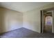 A carpeted bedroom featuring an open doorway to an adjacent room at 10410 N Cave Creek Rd # 2220, Phoenix, AZ 85020