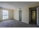 This bedroom has neutral walls, carpet, and doorways to the closet and another room in the home at 10410 N Cave Creek Rd # 2220, Phoenix, AZ 85020