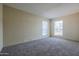 This bedroom has neutral walls, carpet, and two windows that let in lots of natural light at 10410 N Cave Creek Rd # 2220, Phoenix, AZ 85020