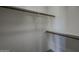 A simple walk-in closet featuring white walls, wood shelves, and hanging rods at 10410 N Cave Creek Rd # 2220, Phoenix, AZ 85020