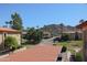 View from a rooftop overlooking the community, palm trees, and a mountain in the distance at 10410 N Cave Creek Rd # 2220, Phoenix, AZ 85020