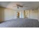 Inviting living room with neutral walls, carpet, ceiling fan, and open doorways to other rooms in the home at 10410 N Cave Creek Rd # 2220, Phoenix, AZ 85020